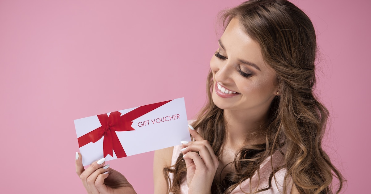 beautiful-woman-giving-gift-voucher
