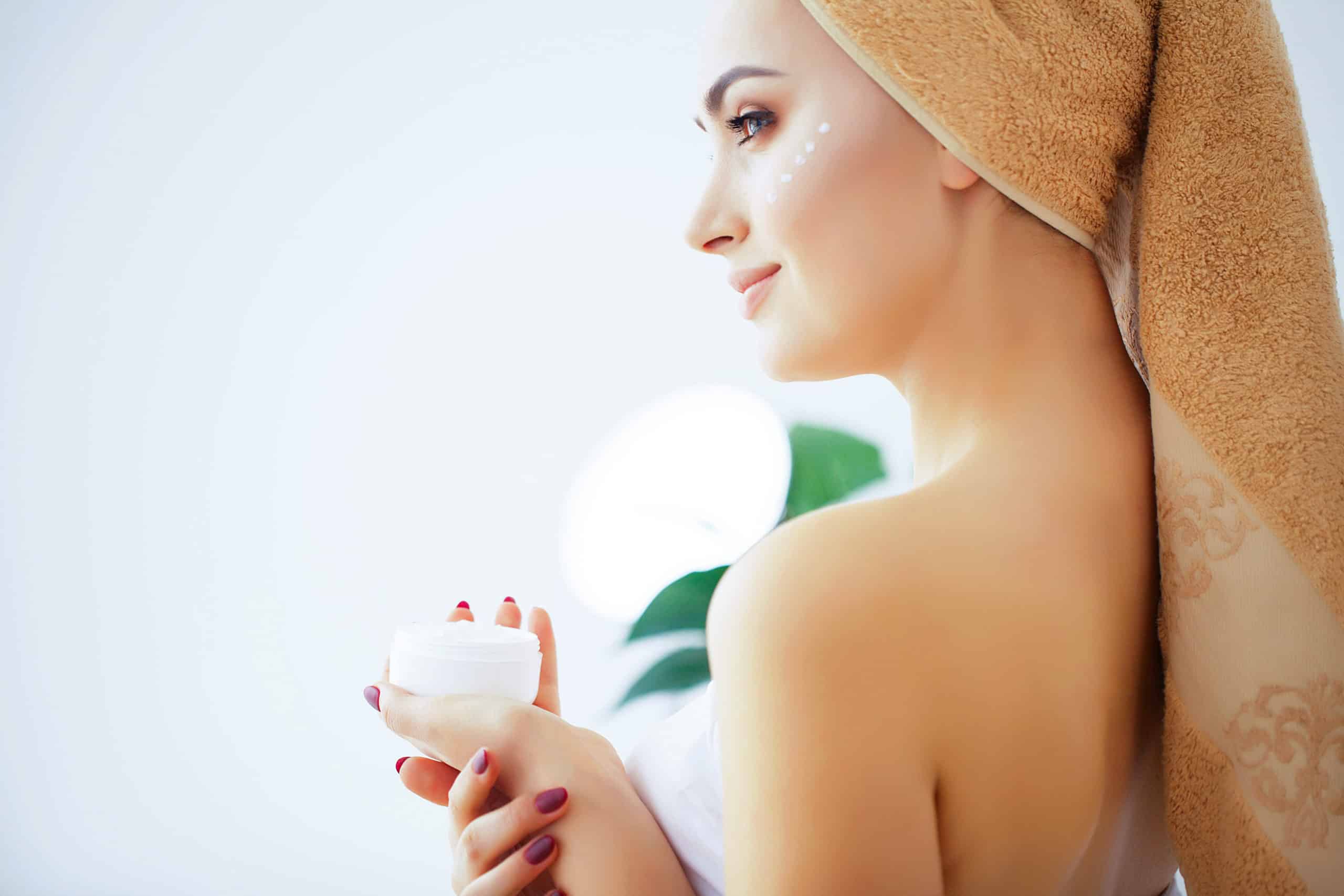 beauty-care-woman-with-pure-skin-towel-head-pour-scaled