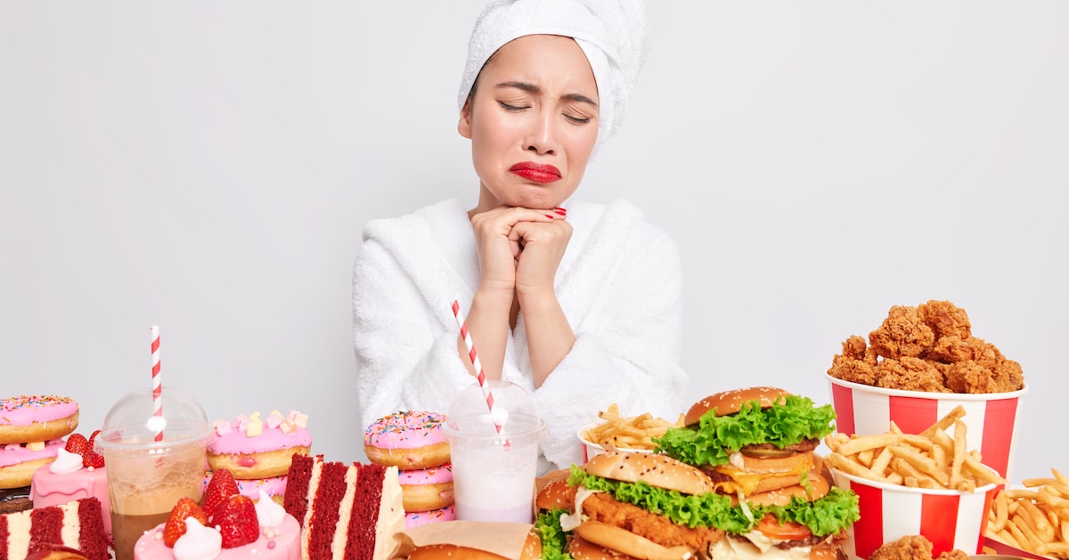 binge-eating-concept-stressed-unhappy-asian-lady-wants-eat-fast-food