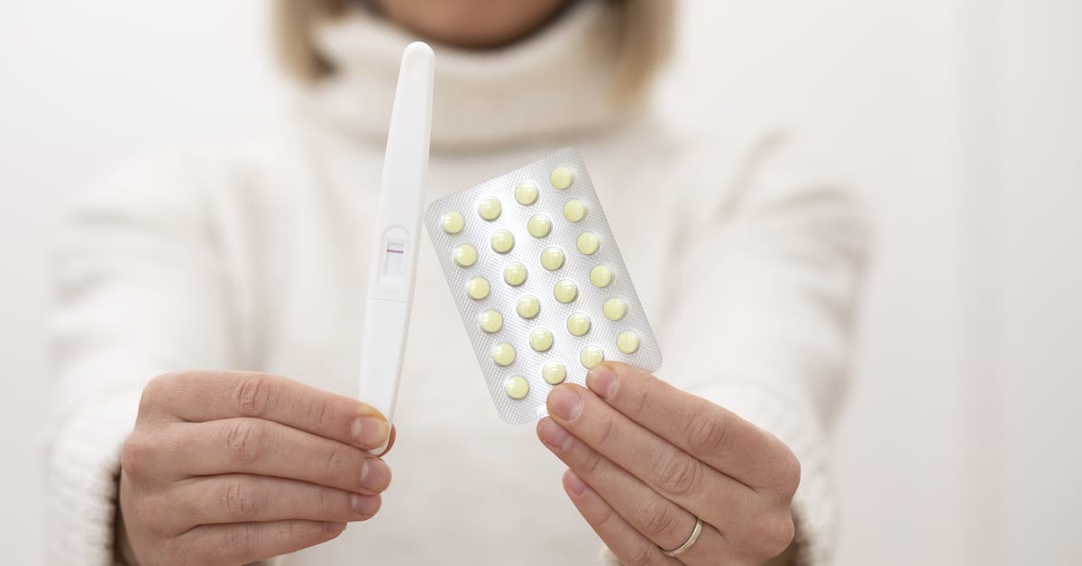 close-up-woman-holding-pills-pregnancy-test