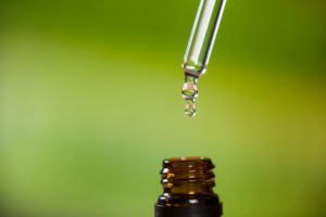 drop-of-oil-dripping-from-pipette-into-bottle-of-essential-oil_1252-937-300x200