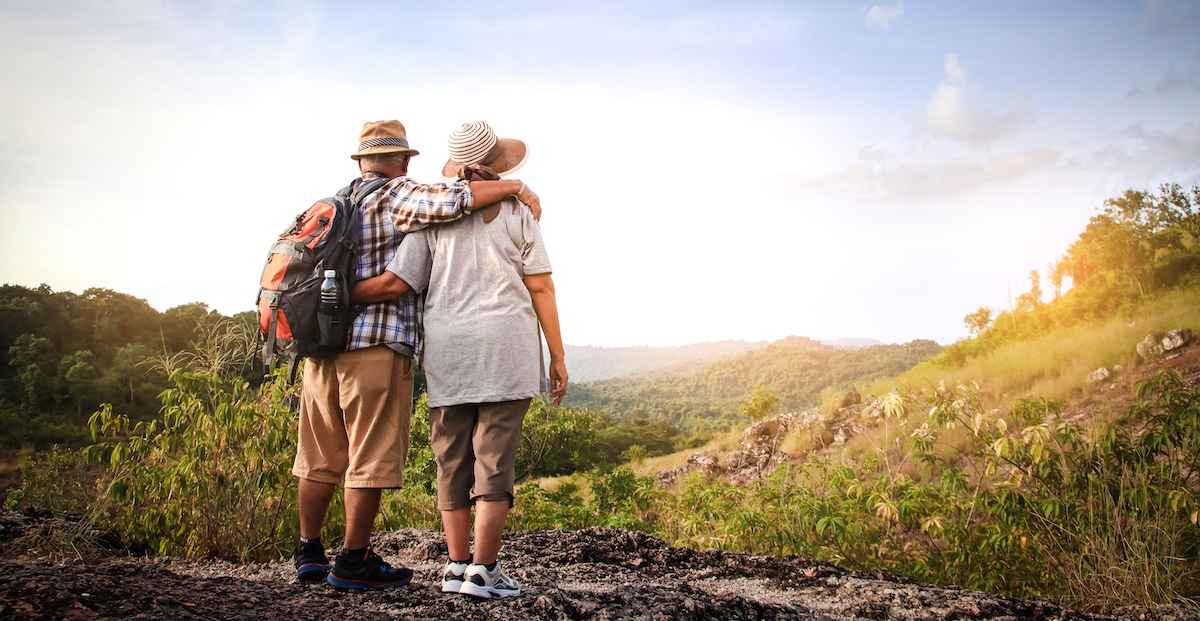 elderly-couple-hiking-standing-high-mountain-are-happy-retirement