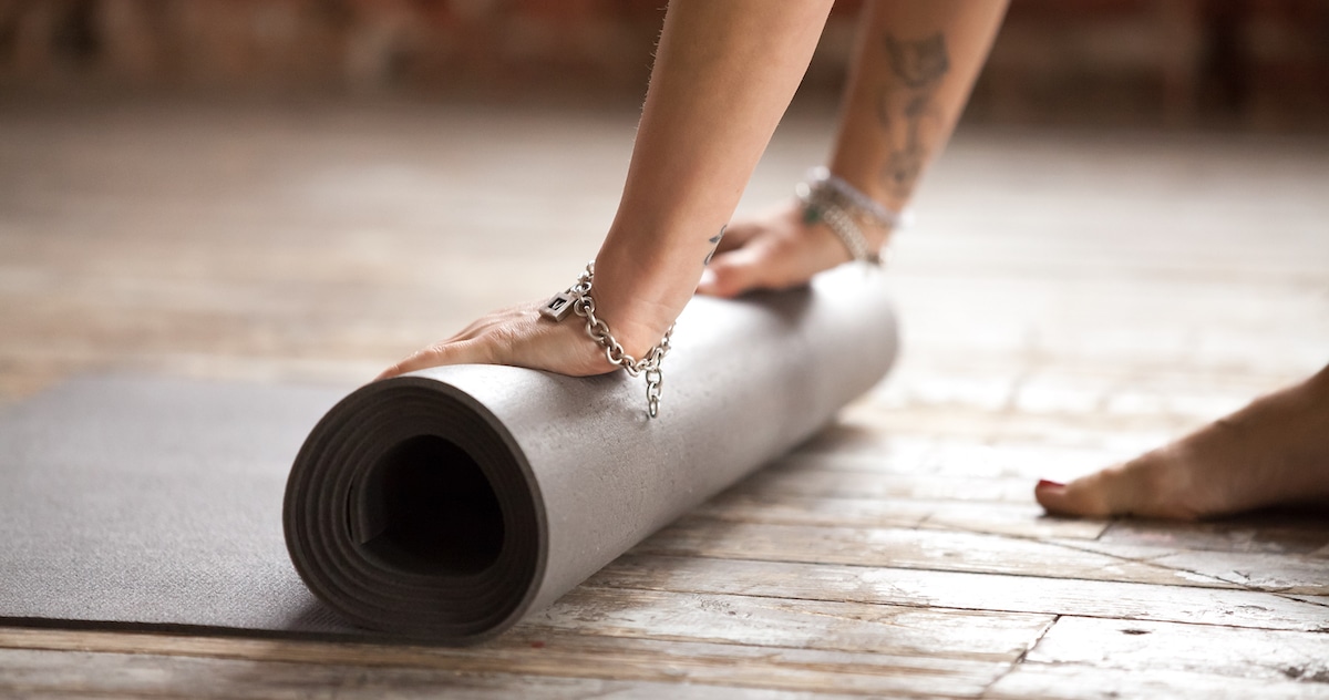 hands-rolling-fitness-mat-concept-healthy-lifestyle