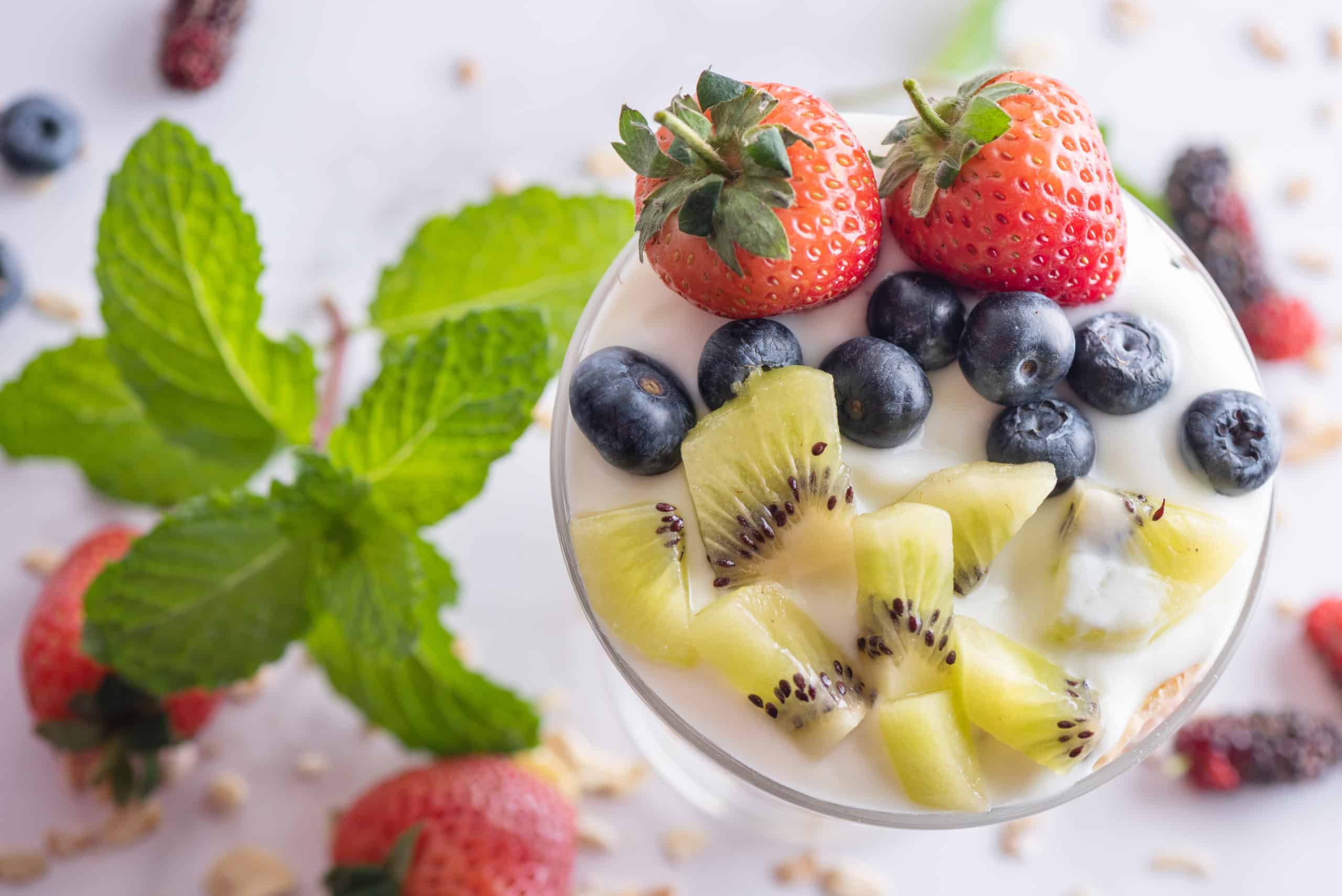homemade-muesli-bowl-oat-granola-with-yogurt-fresh-blueberries-mulberry-strawberries-kiwi-mint-nuts-board-healthy-breakfast-copy-space-healthy-breakfast-concept-clean-eating-scaled