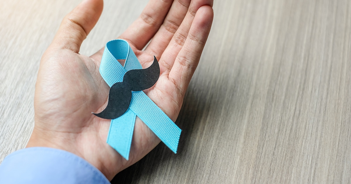 prostate-cancer-awareness-man-holding-light-blue-ribbon-with-mustache