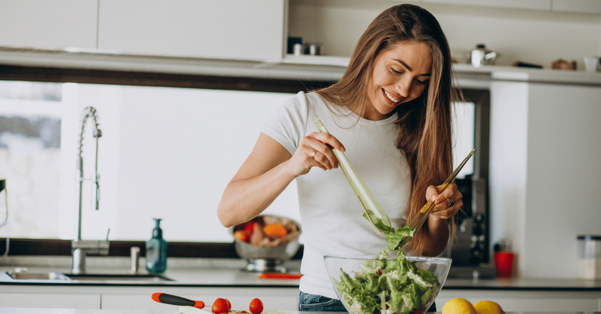woman-in-kitchen-making-salad