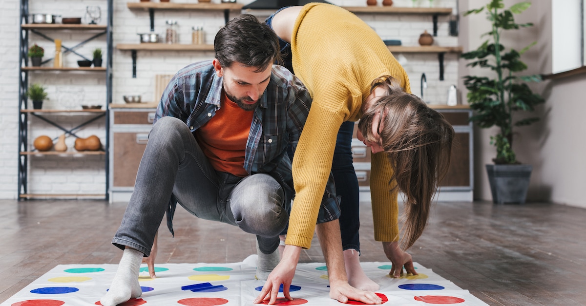 young-man-playing-twister-game-with-her-wife-home