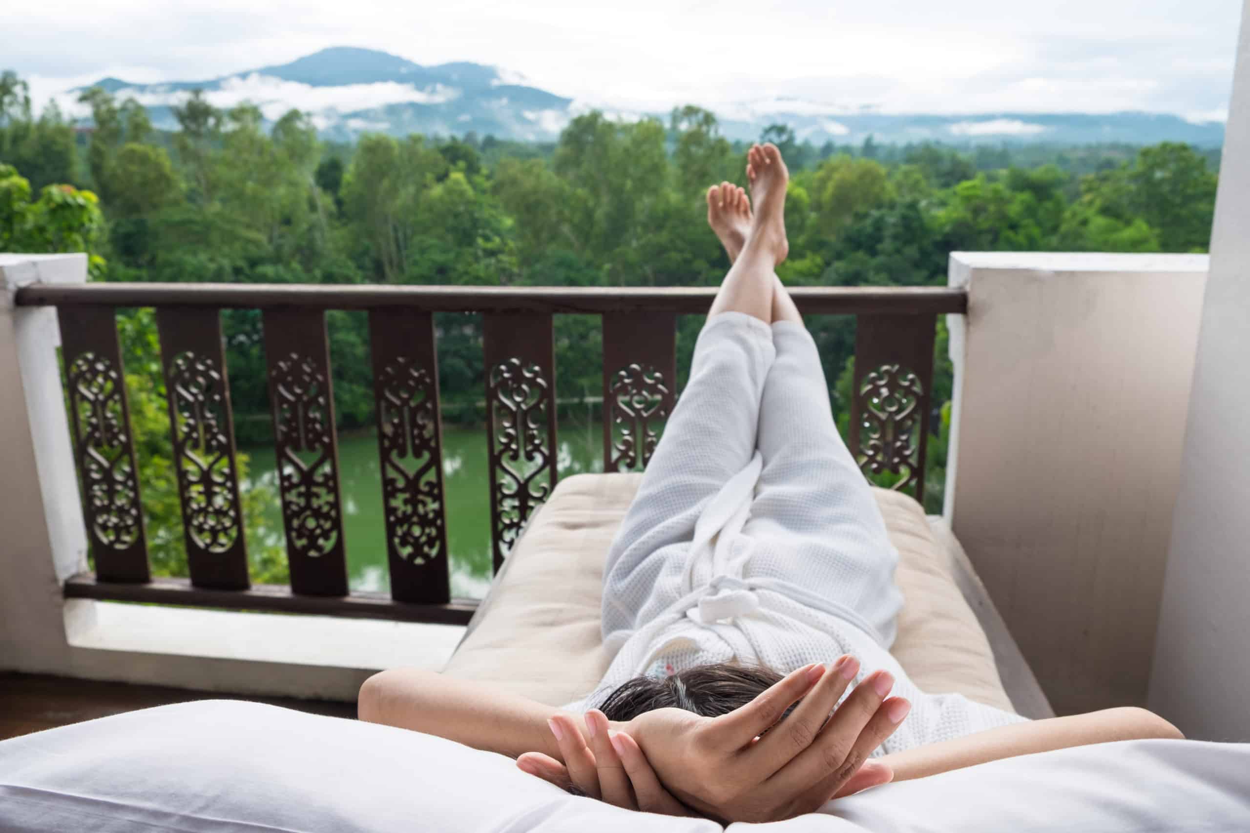 young-woman-relax-bed-enjoying-mountain-view-1-scaled